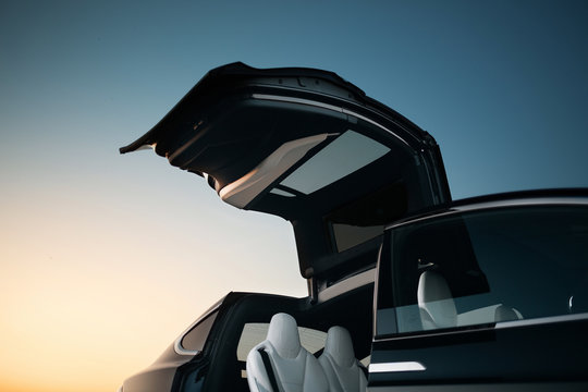 Modern suv car vertical door. Crossover with futuristic doors at the evening desert