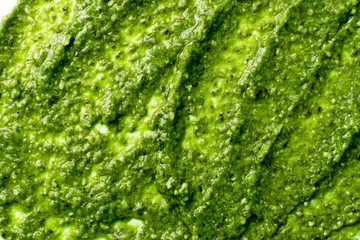 Frersh italian pesto sauce spread green texture background