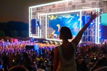 Woman is dancing at open air music festival