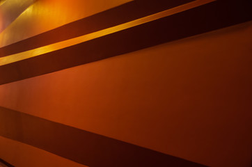 Geometric shaped orange wall illuminated architectural background