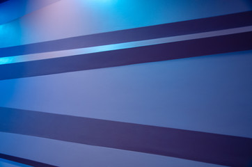 Obraz premium Geometric shaped blue wall illuminated architectural background