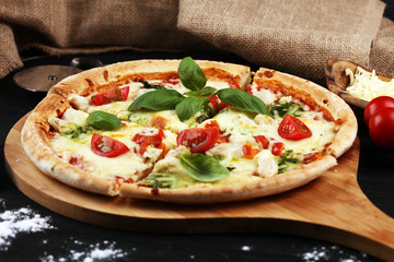 vegetarian italian Pizza with tomatoes, mozzarella cheese  and basil. Delicious italian pizza