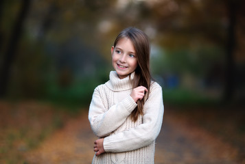 portrait of cute girl in autumn park