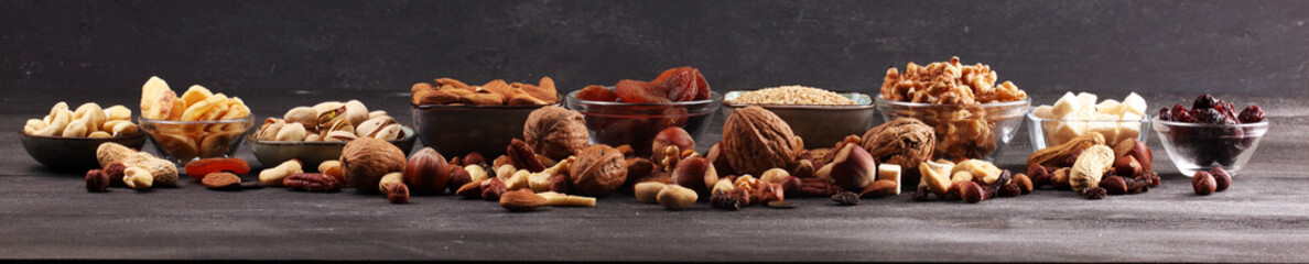 Composition with dried fruits and assorted healthy nuts on rustic background