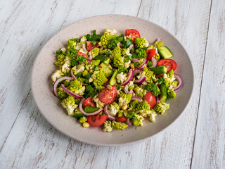 Fresh vegetable salad with cabbage romanesco and olive oil. Top view.