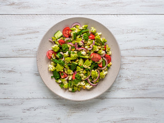 Fresh vegetable salad with cabbage romanesco and olive oil. Top view.