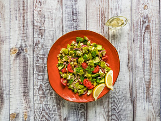 Fresh vegetable salad with cabbage romanesco and olive oil. Top view.