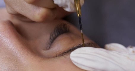 Asian woman gets facial beauty procedure, microblading procedure