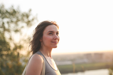 caucasian woman in sports in park at sunset,