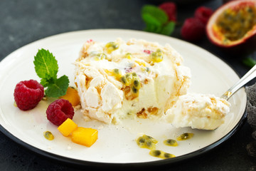 Meringue roulade with raspberries and passion fruit. Pavlova. Dessert. Selective focus