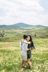 Portrait of a beautiful young adult girl hugging a man