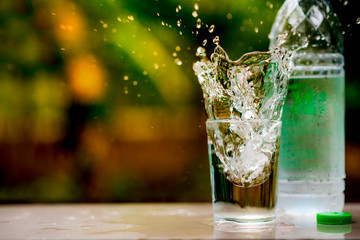 A glass of clean drinking water and spill