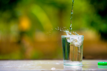 A glass of clean drinking water and spill