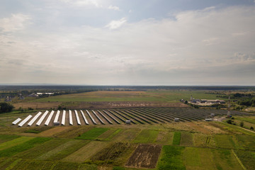 Fototapeta na wymiar Aerial view of solar power plant. Electric panels for producing clean ecologic energy.