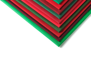 Stack of red and green fabrics on white background, space for text