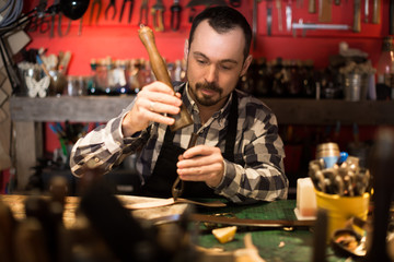 Hard-working man working on belt leather