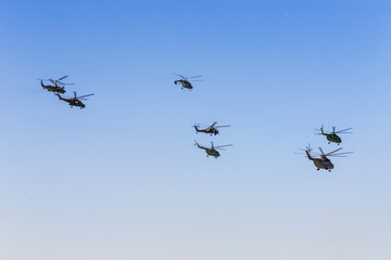 The flight of a group of military helicopters holding.