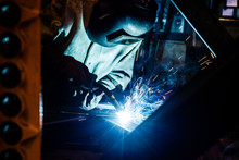 Welder working in factory
