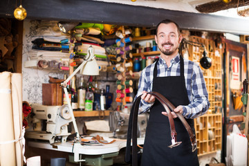 Fototapeta premium Worker demonstrating assortment in leather
