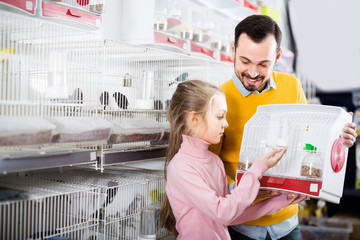 Father and  daughter boasting their purchase of bird
