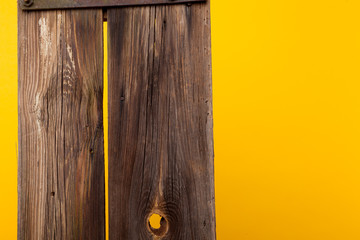 Old wooden bulletin board on yellow background