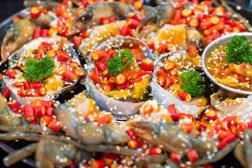 Spicy fresh raw blue crab salad with many chili and seafood sauce. popular thai food.