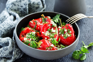 Baked bell peppers salad with herbs and garlic. Eastern dish.