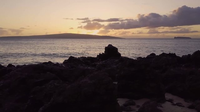 Tracking Shot Of A Tropical Sunset With Islands And Volcanic Rock