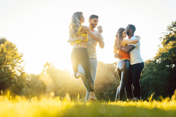 Group of people dancing Kizomba in sunset