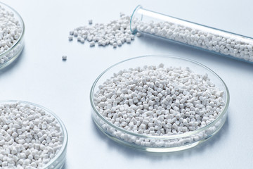 A table in a chemical laboratory with granules and chemical glassware