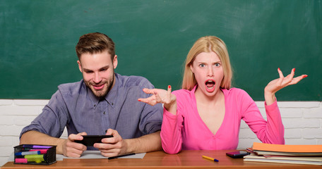 Couple friends students studying university. Surprising answer. Studying hard. How is it possible. Guy and girl sit at desk in classroom. Wondering about result. Studying in college or university