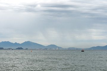 Seascape on the coast of Vietnam with a view of the mountains, boats and the city of Da Nang. Hoi An, Vietnam