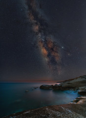 Naklejka na ściany i meble Milky way rising above White Stones beach in Limassol, Cyprus
