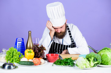 Hard day at restaurant. Tired and exhausted chef. Man bearded chef cooking food. Chef fed up of boring meals. Looking for inspiration. Bored chef lean on table at kitchen. Culinary inspiration