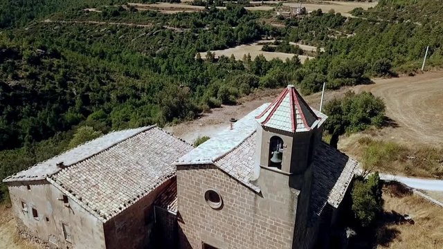 Aerial view of the Riner castle, church and tower near Solsona, Catalonia, Spain, Europe.
Dolly shot, pull back over the church, revealing the tower.