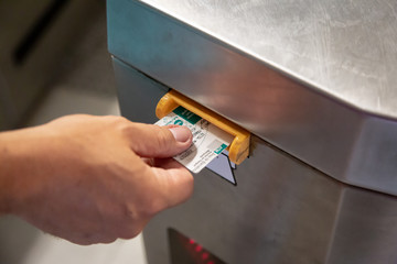 A passenger passes through an automatic ticket checking machine at a metro station