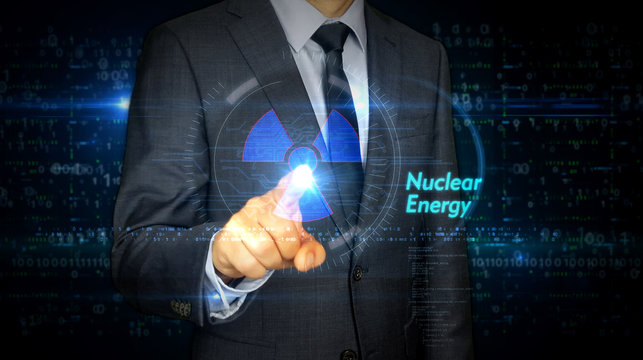 Businessman touch screen with nuclear energy symbol hologram