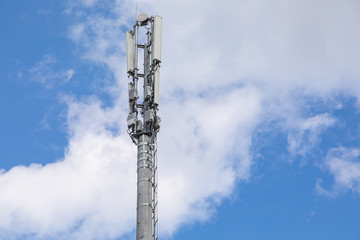 Close-up of pole with electricity transmission pole against blue sky