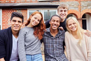 Portrait Of Group Of Smiling College Students Outside Rented Shared House