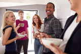 Group Of College Students In Shared House Kitchen Eating Breakfast Together