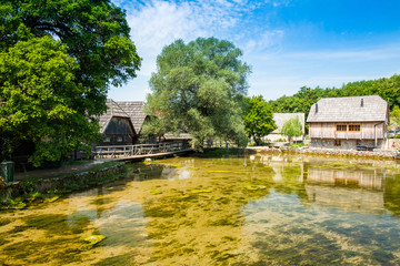 Obraz premium Croatia, region of Lika, Majerovo vrilo river source of Gacka, traditional village, old wooden mills and cottages