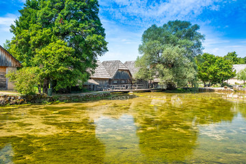 Fototapeta na wymiar Croatia, region of Lika, Majerovo vrilo river source of Gacka, traditional village, old wooden mills and cottages