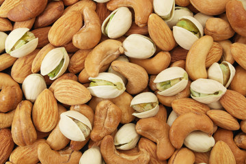 Mixed nuts background, almonds, pistachios, cashews 
