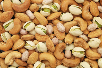 Mixed nuts background, almonds, pistachios, cashews and peanuts