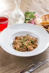 stir fried yakisoba noodle with pork Asian food style with red drink on wooden table