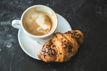 Cup of cappuccino and croissant