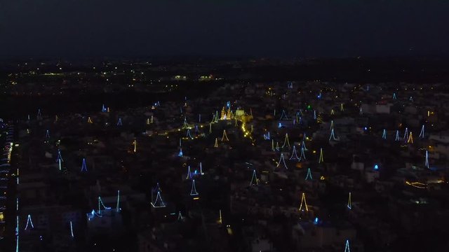 night aerial shot over the colorful decoration lights for village fest, Zurrieq
