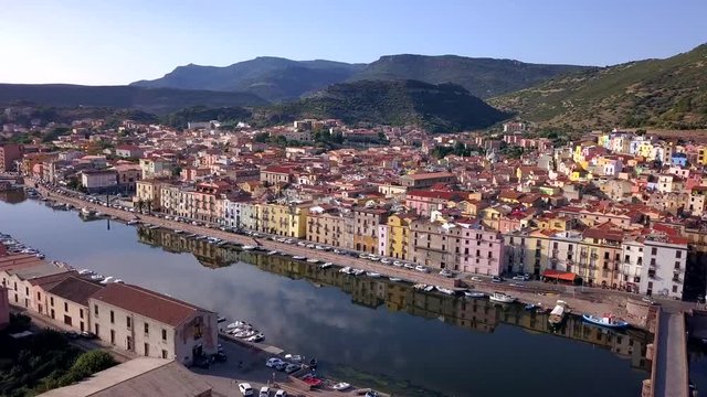 Bosa, Sardinia, Italy -Drone Arerial Shot discovering the colourful town of Bosa with a wonderful reflection on the river Temo. A typical Italian and mediterranean landscape