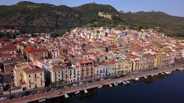 Bosa,Sardinia, Italy - Drone aerial shot of the colourful town of Bosa in Sardinia.Bank turn right over the river temo with awesome green landscape.