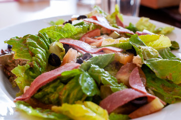Greek salad served in a white porcelain plate